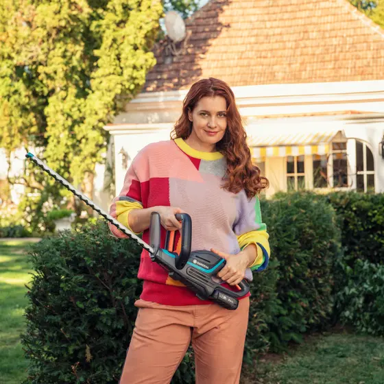 A man cleaning his bike with a battery medium pressure cleaner